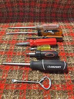 All seven screwdrivers laid out on patterned surface