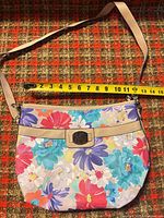 Full view of purse with measuring tape indicating width ~12-14 in