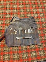 Rolled-out canvas pouch showing all tools