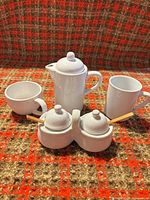 Full set showing coffee pot, two cups, double sugar bowl with lids and spoons