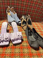 All four pairs of shoes displayed on patterned surface