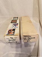 Two cardboard long boxes, one labelled 1992 Score Hockey, one labelled 1993/94 OPC Premier #2