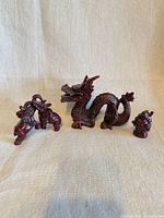 Group view of dragon, two elephants, and Buddha figurines