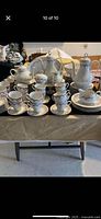 Full view of 94-piece porcelain dinner set displayed on table