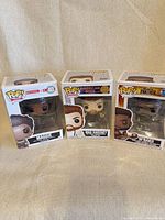 Front view showing three boxed Funko Pop! figures Maggie #40, Mad Sweeney #681, M'Baku #388