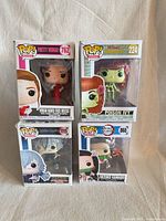 Front view of all four boxed Funko Pop figures