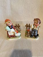 Front view of both porcelain figurines