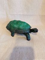 Full view of malachite glass turtle trinket box with lid on