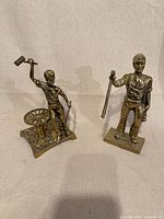Both brass worker figurines front view