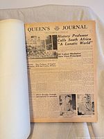 Open volume showing front page of issue No.1, Queen's Journal September 1959