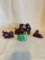 Front view of all four resin horse figurines