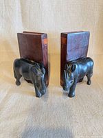 Angled front view of both bookends showing rhinoceros figures and block backs