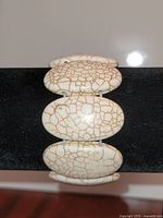 Bracelet front view showing cream color and gold crackle design