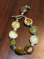 Full view of bracelet showing polished stone beads and toggle clasp