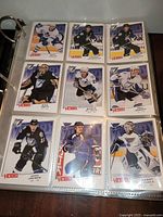Binder page showing nine 2008-09 Upper Deck Victory hockey cards