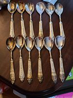 Twelve matching silverplate spoons displayed on tabletop