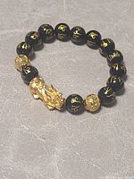 Full view of stretch bracelet showing bead pattern and Pixiu charm
