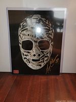 Front view of signed Gerry Cheevers mask photo in sleeve