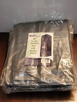 Two sealed packages of SimpleHouseware 60" travel garment bags, labels visible