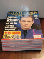 Top magazine showing Connor Trinneer cover on stack of Star Trek magazines