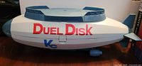 Front view of blimp showing Duel Disk and Kc logos