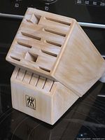 Full view of angled wooden knife block showing slot arrangement