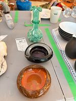Lot overview showing green bud vase, amber bowl, purple bowl