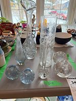 Group shot of all seven clear glass vases on table