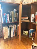 Open cabinet filled with two shelves of assorted books