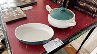 oval dish and lidded casserole on table