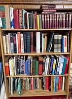 Overall view of four bookshelves filled with assorted books