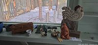 All items on shelf including rooster, gnome, chest, planter, hen and chick figurines