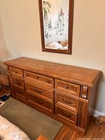 Full front view of dresser showing nine drawers and brass pulls