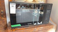 Front view of Panasonic microwave showing glass door and control panel
