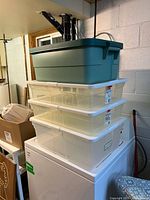 Stacked green tote on three clear bins
