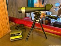 Polaroid camera and telescope on tripod overview