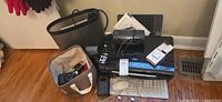 Group shot showing printer, Apple peripherals, cameras, iPod package, basket