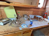 Overall lot with scale, decanter set, bowls, racks