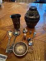 Overview of all sterling items: cup, vase with insert, four spoons, tea strainer