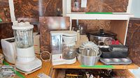 Group shot showing blender, toaster, coffee maker, crock pot, Bundt pan, loaf pans, baking pan