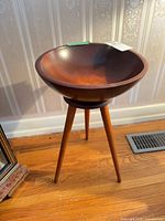 Full view of wooden standing bowl on three legs