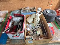 Overview of two cartons with electrical parts and nearby tires