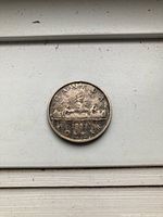 Reverse of 1953 Canada silver dollar, Voyageur design visible