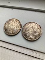 Front view of both 1966 silver dollars showing canoe reverse design