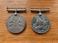 Both medals front views on wood surface