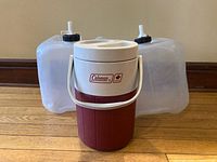Front view showing Coleman jug and two clear water jerry cans