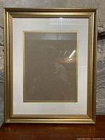 Front view of gold frame with mat