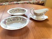 Full view of both vegetable dishes, gravy boat and saucer