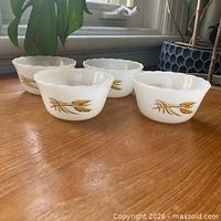 Four Fire-King Wheat dessert bowls angled view showing exterior wheat design