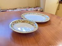 Top view of both serving pieces on table showing pattern and size relationship